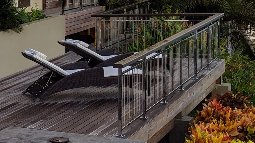 Deck cable railing with vertical infill.