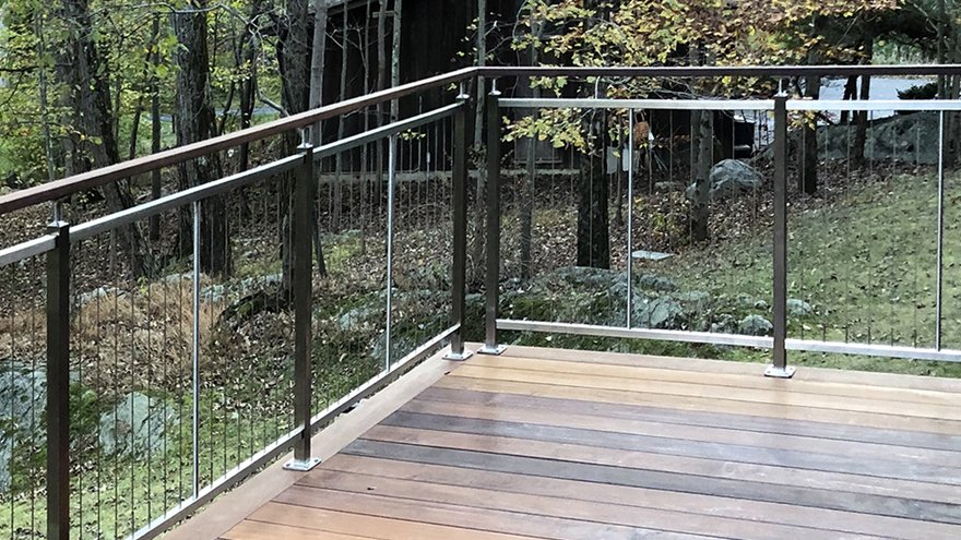 Vertical cable deck railing system.