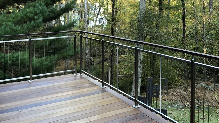 Deck rail with vertical cable infill.